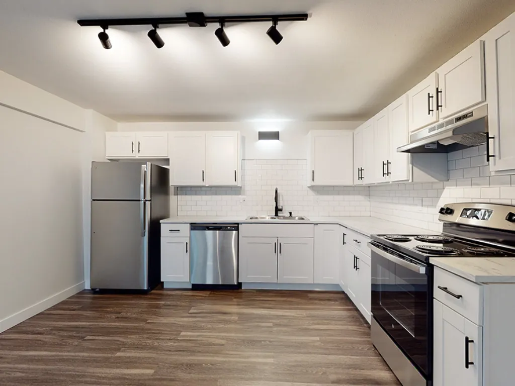 resources_566dfdfe-be57-42a1-8b2a-5808fdcc0a70 Modern kitchen with white cabinets and appliances.